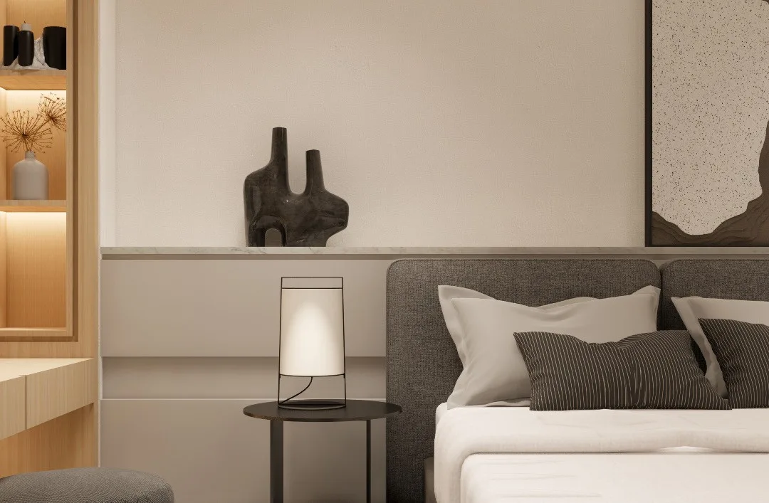 Bedroom detail with ceramic objects and a grey upholstered bed