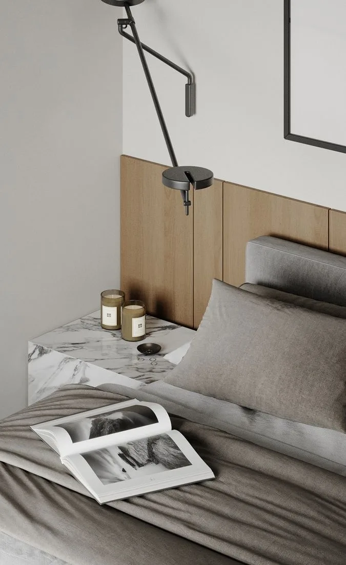 Bed with linen and an articulated reading light