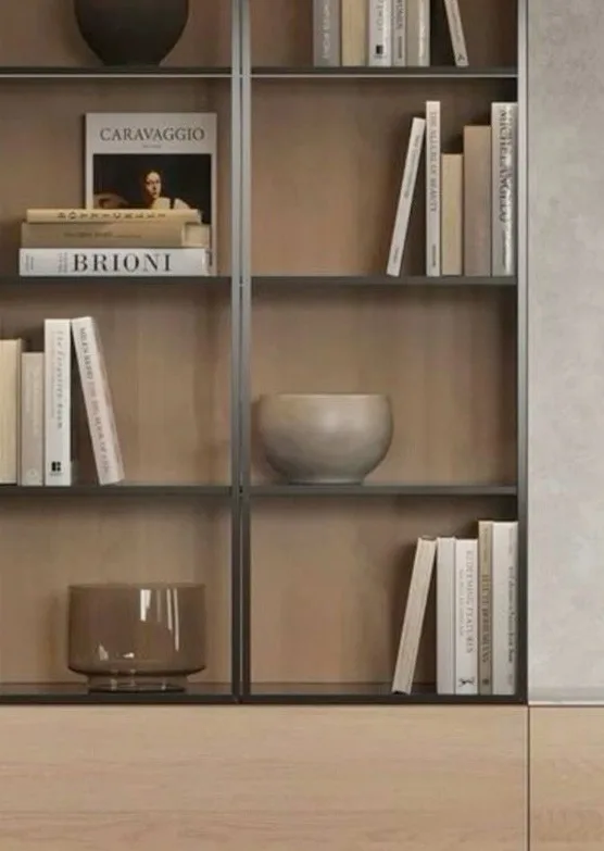 Timber and metal bookshelf with books and objects