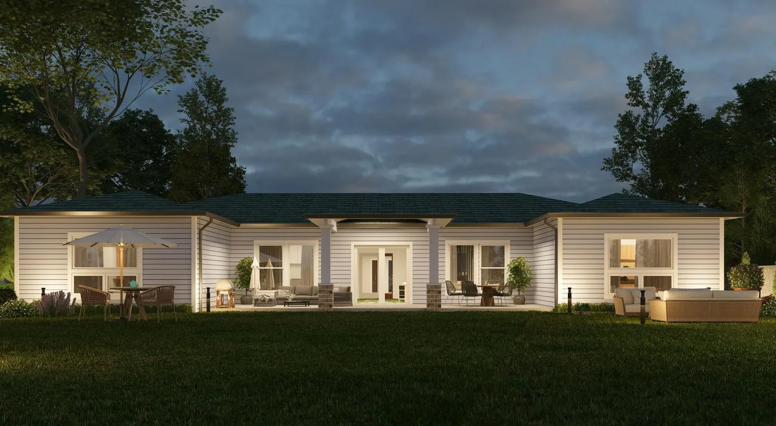 Single-storey cottage at dusk with lit interiors